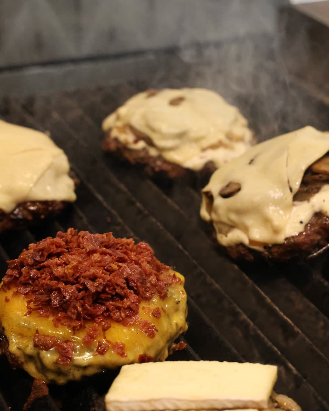 Burgers on the grill with melted cheese